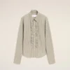 Camicia aderente con volant a maniche lunghe in cotone beige Camicia aderente con volant a maniche lunghe in cotone beige