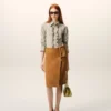 Camicia aderente con volant a maniche lunghe in cotone beige Camicia aderente con volant a maniche lunghe in cotone beige