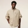 Camicia Ami de Coeur in cotone beige dal taglio squadrato con ricami Camicia Ami de Coeur in cotone beige dal taglio squadrato con ricami