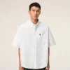 Camicia bianca in cotone dal taglio squadrato con ricamo Ami de Coeur Camicia bianca in cotone dal taglio squadrato con ricamo Ami de Coeur