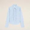 Camicia blu in cotone a maniche lunghe con volant e vestibilità aderente Camicia blu in cotone a maniche lunghe con volant e vestibilità aderente