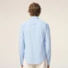 Camicia blu in cotone a maniche lunghe con volant e vestibilità aderente
