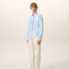Camicia blu in cotone a maniche lunghe con volant e vestibilità aderente