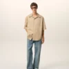 Camicia lunga a maniche corte in cotone beige con collo alla camp Camicia lunga a maniche corte in cotone beige con collo alla camp