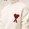 Maglione a collo a imbuto in lana naturale con Ami de Coeur a contrasto Maglione a collo a imbuto in lana naturale con Ami de Coeur a contrasto