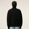 Maglione nero in lana con collo a imbuto e Ami de Coeur a contrasto Maglione nero in lana con collo a imbuto e Ami de Coeur a contrasto