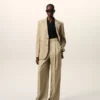 Pantaloni beige in lana vergine a vita alta e gamba larga